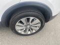 A close-up of a silver 2018 Buick Encore's alloy wheel and tire showing the Bridgestone tire brand and detailed rim design