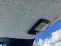 Interior view of a 2010 New Holland T4050 tractor with a close-up of the ceiling fabric and an overhead light switch