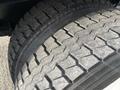 Close-up of a worn tire from a 2011 International 4300 showing distinct tread patterns and grooves