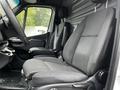 Interior of a 2019 Mercedes-Benz Sprinter showing two black fabric seats with a textured pattern and a dashboard with controls