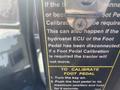 Close-up of a warning label on a Trackless MT6 detailing foot pedal calibration instructions and troubleshooting for the tractor's hydrostat ECU and pedal disconnection