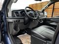 Interior view of a 2020 Ford Transit showing the driver's seat steering wheel and dashboard with various controls and a modern display