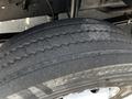 A close-up view of a worn tire showcasing visible tread patterns and slight wear on the rubber surface