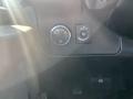Dashboard controls of a 2013 Chevrolet Express featuring a round dial for headlights and a switch for interior lights