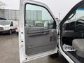 A 2006 Ford F-450 with the driver's side door open displaying the interior and door panel features