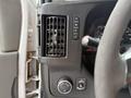 Interior dashboard of a 2015 Chevrolet Express showing air vent control buttons and steering column with gauge display