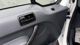 Door panel of a 2012 Ford Transit featuring a control switch and speaker grille