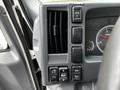 Dashboard controls of a 2018 Isuzu NPR featuring air vents and buttons for various functions