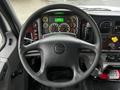 Steering wheel and dashboard of a 2018 Freightliner M2 106 displaying various gauges and controls