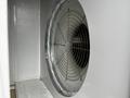 A Huntair Custom Air Handler Unit featuring a large circular fan with a wire grid and a smooth white interior