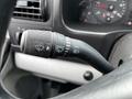 A close-up of the control stalk on a 2007 Ford F-550 featuring symbols for headlights and windshield wipers