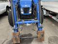 A blue 2016 New Holland T475 tractor with large tires and a front loader attachment positioned low to the ground