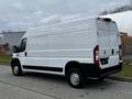 A white 2021 RAM Promaster van with no windows on the sides and rear facing to the right showing a simple and clean design
