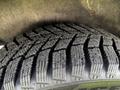 The image shows a close-up of a tire from a 2016 Ford Transit Connect featuring deep tread patterns designed for improved grip and traction on various surfaces