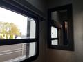 A 2021 Grand Design Recreational 311BHS with a sleek design featuring large windows and a modern mirror on the wall
