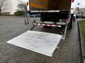 A 2022 Ford F-750 with a lowered hydraulic liftgate in the rear ready for loading or unloading cargo