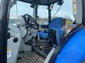 Cab interior of a 2016 New Holland T475 tractor featuring a blue seat steering wheel and control levers