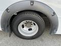 Close-up of a tire and wheel of a 2018 Chevrolet Express showing the rim and a black fender flare around the wheel arch