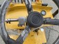 A top-down view of the steering wheel and control panel of a yellow 2024 AGT KRW 23 Mini loader with protective wrap on the steering wheel