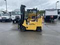 A yellow 2010 Hyster S80XLBCS forklift with a power steering system and an extended mast is positioned on a surface with visible tire marks