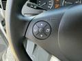 Steering wheel controls of a 2016 Mercedes-Benz Sprinter featuring directional buttons and a central button for navigation or settings