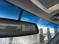 A rearview mirror displaying a travel height label indicating 10 ft 4 in and 3.2 metres inside a 2016 Ford F-550