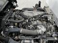 Close-up view of a 2018 Isuzu NPR engine with various pipes and components including hoses and an air intake system visible in the foreground