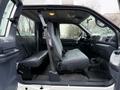Interior of a 2001 Ford F-350 showing front bench seat with seatbelt fastened and dashboard features