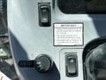 Control panel of a 2018 New Holland Boomer 45 tractor featuring various switches and a warning label about engine start and oil temperature range