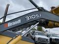 A 2012 John Deere 310SJ backhoe loader with a metallic arm featuring the Brandt logo and model number 310SJ prominently displayed