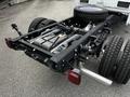 A 2024 Ford F-550 chassis showing the undercarriage, rear tires, and exhaust system with fuel tank and mounting points visible