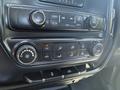 Dashboard controls of a 2016 GMC Sierra 1500 featuring climate control knobs and media buttons