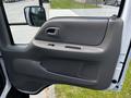 A close-up of the door panel of a 2009 Ford LCF 550 showing a gray interior handle and armrest with a textured surface