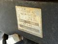 A close-up of a metal identification plate from a 2011 Kubota M8540D tractor displaying model information and manufacturing details