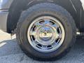 A chrome wheel of a 2016 Ford F-150 with a rugged tire labeled Discoverer AT3 LT