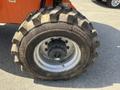 2008 JLG Boom Lift tire with textured tread and a metallic rim showing wear and dirt