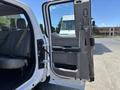 A 2016 Ford F-150 with the front driver's door open showcasing the interior and seat upholstery