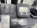 A close-up view of a control panel featuring a digital display screen with buttons and an odometer on a 2011 Toyota 028FG15 forklift