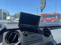 A dashboard of a 2015 Ford F-450 SD featuring a touchscreen display and control buttons