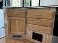 Wooden drawer and cabinet unit with gold handles inside a 2000 Ford Motorhome