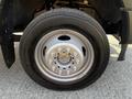 Close-up of a silver wheel and tire on a 2021 Ford F-550 showcasing the tire tread and wheel design
