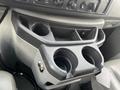 The image shows the center console of a 2009 Ford Econoline featuring cup holders and compartments for storage