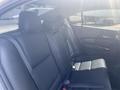 The interior of a 2017 Acura TLX with black leather seats in the back row featuring headrests and sleek design elements