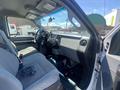 Interior view of a 2016 Ford F-350 SD showing two front seats a dashboard and steering wheel with controls and a gear shift