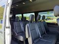 Interior view of a 2023 Mercedes-Benz Sprinter showing multiple black leather seats arranged in a row with seatbelts