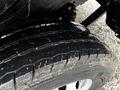 Close-up of a 2018 RAM Promaster tire showing a rugged tread pattern with some dirt and debris on the surface