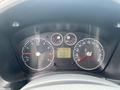 Dashboard of a 2013 Ford Transit Connect showing speedometer tachometer and warning lights