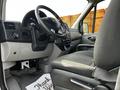 Interior view of a 2017 Mercedes-Benz Sprinter showcasing the steering wheel and driver's seat with a thank you mat on the floor