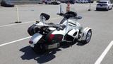 A white 2013 Can-Am Spyder with a rear trunk and two front wheels designed for stability and performance