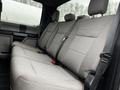 Interior view of the rear seats in a 2020 Ford F-350 SD with gray fabric upholstery and seatbelts attached